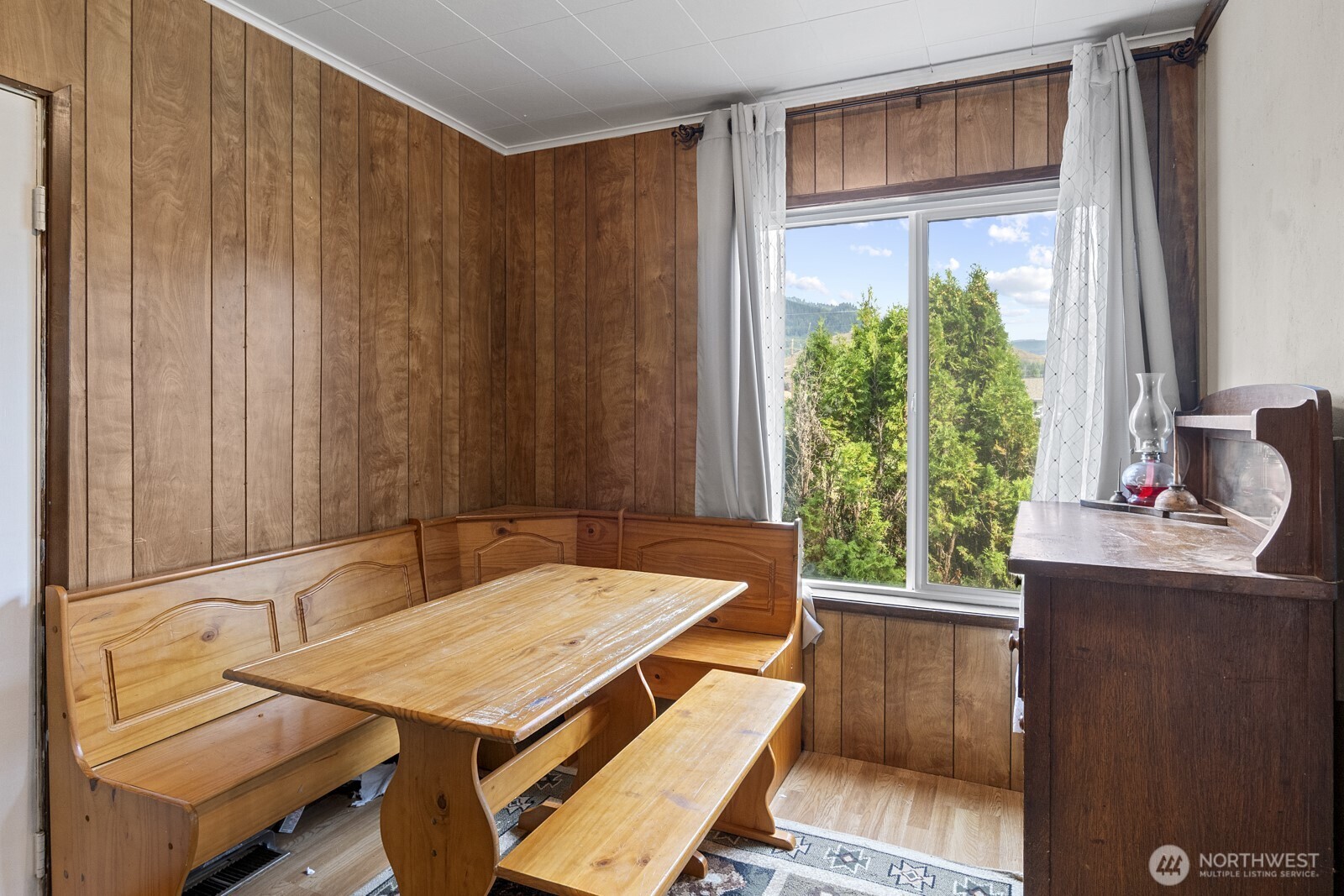 325 3rd Street Morton, WA 98356 - Photo 13 of 40 a table and chairs in a room next to a window