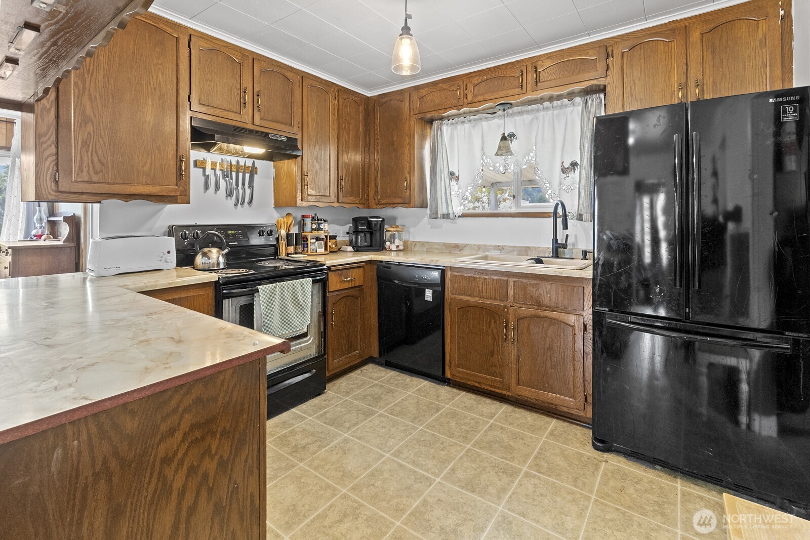 325 3rd Street Morton, WA 98356 - Photo 14 of 40 a kitchen with stainless steel appliances granite countertop a refrigerator sink and cabinets