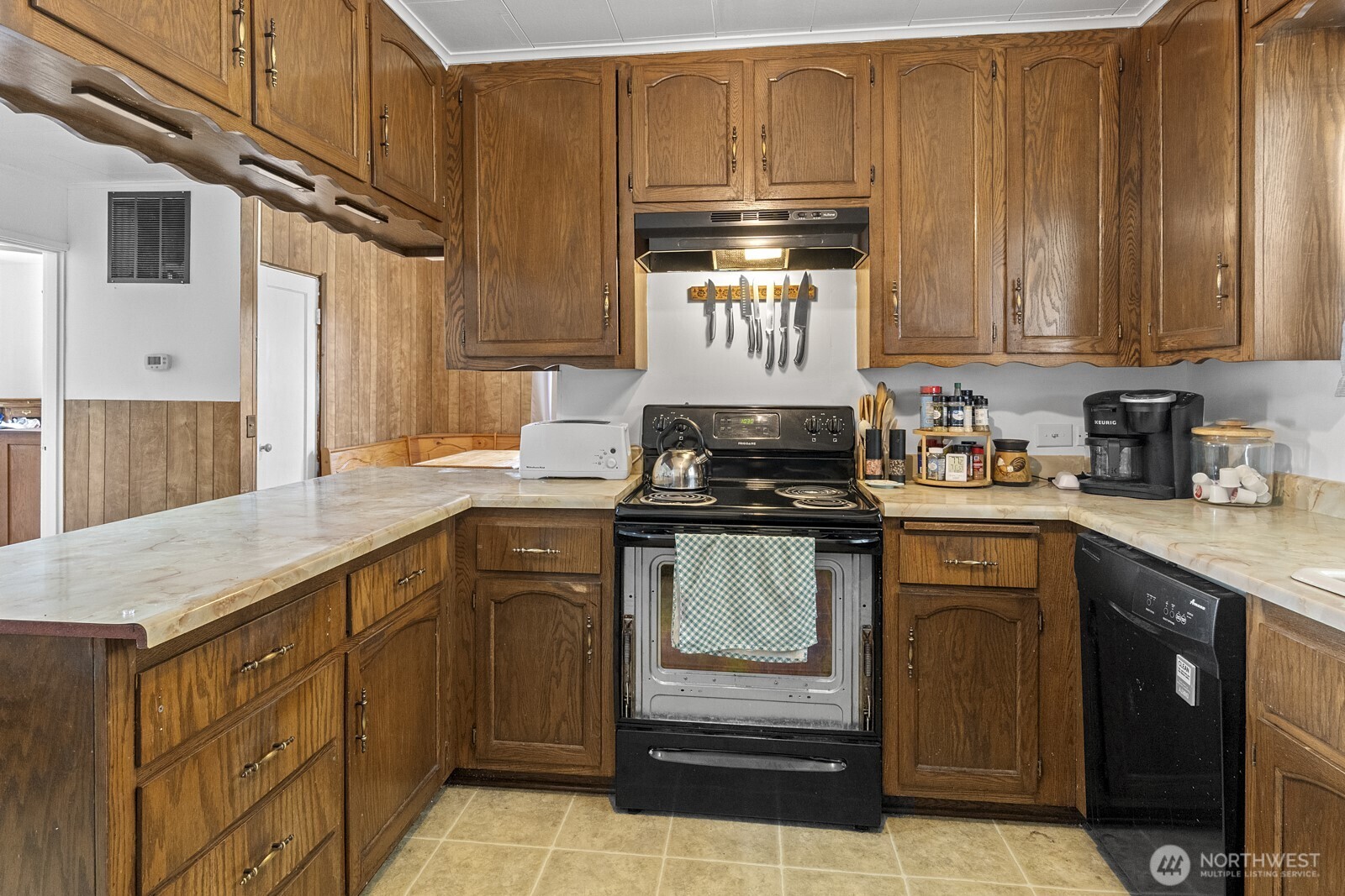 325 3rd Street Morton, WA 98356 - Photo 15 of 40 a kitchen with stainless steel appliances granite countertop a stove a sink and a microwave