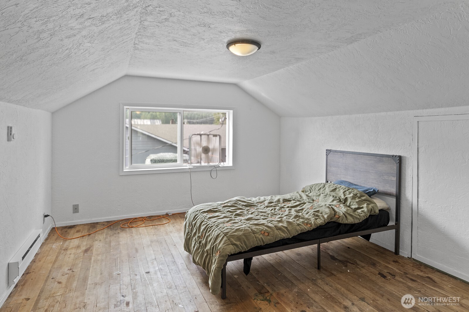 325 3rd Street Morton, WA 98356 - Photo 22 of 40 a bedroom with a bed and a table in it