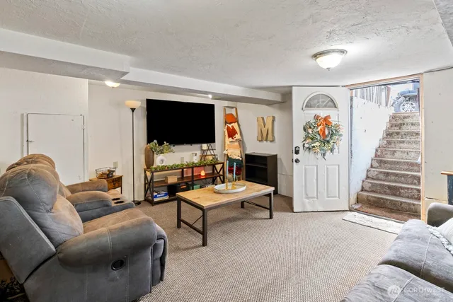 a bedroom with furniture and a large window