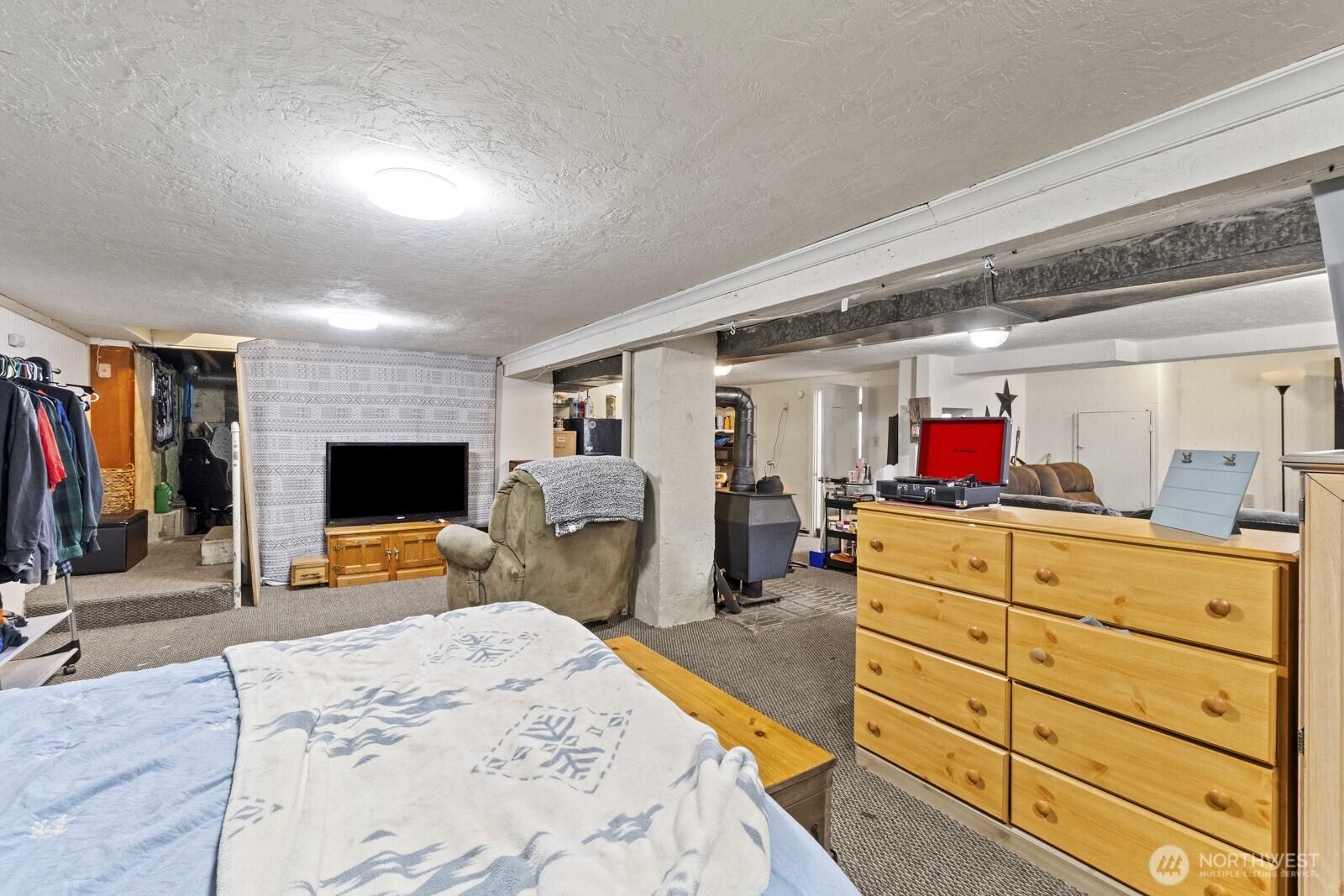 325 3rd Street Morton, WA 98356 - Photo 37 of 40 a bed room with a bed and a flat tv screen