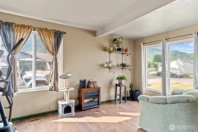 a living room with furniture and a wooden floor