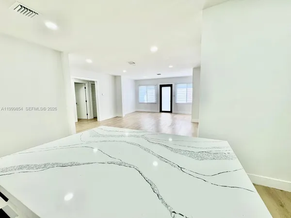 a spacious bedroom with a bed and a cabinets