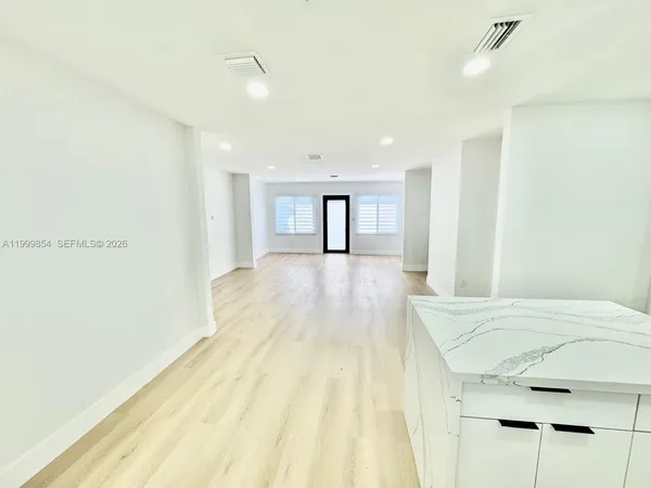 a view of a room with wooden floor and window