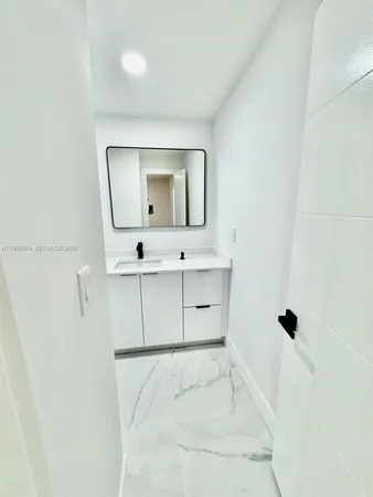 a bathroom with a bathtub sink and mirror