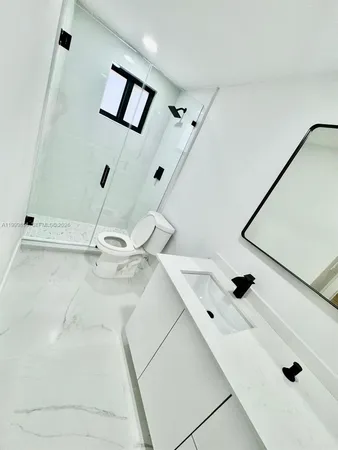 a bathroom with a mirror and a shower