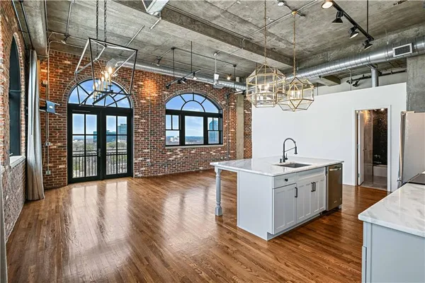 a kitchen with stainless steel appliances granite countertop a sink and stove