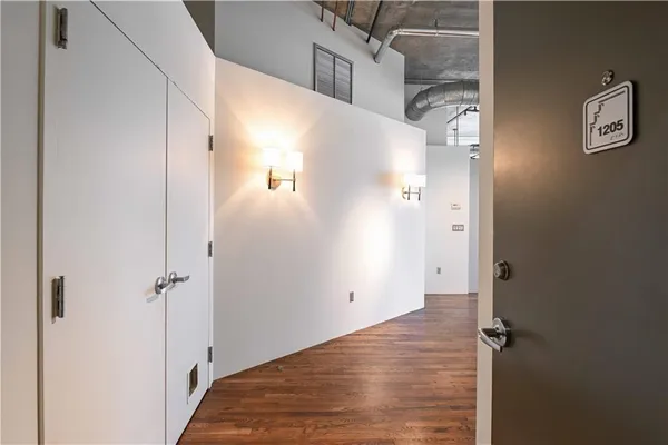 a view of empty room with wooden floor