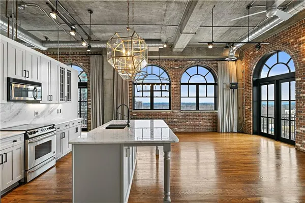 a view of a kitchen with a sink and a refrigerator