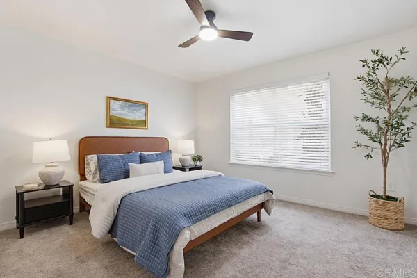 a bedroom with bed and a potted plant