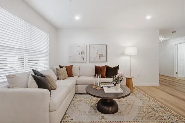 a living room with furniture and a wooden floor