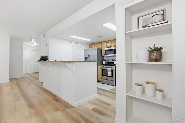 a kitchen with stainless steel appliances granite countertop a refrigerator and a sink