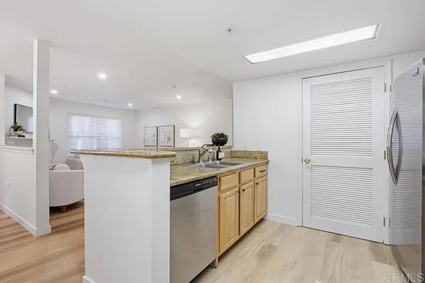 a kitchen with kitchen island sink and refrigerator