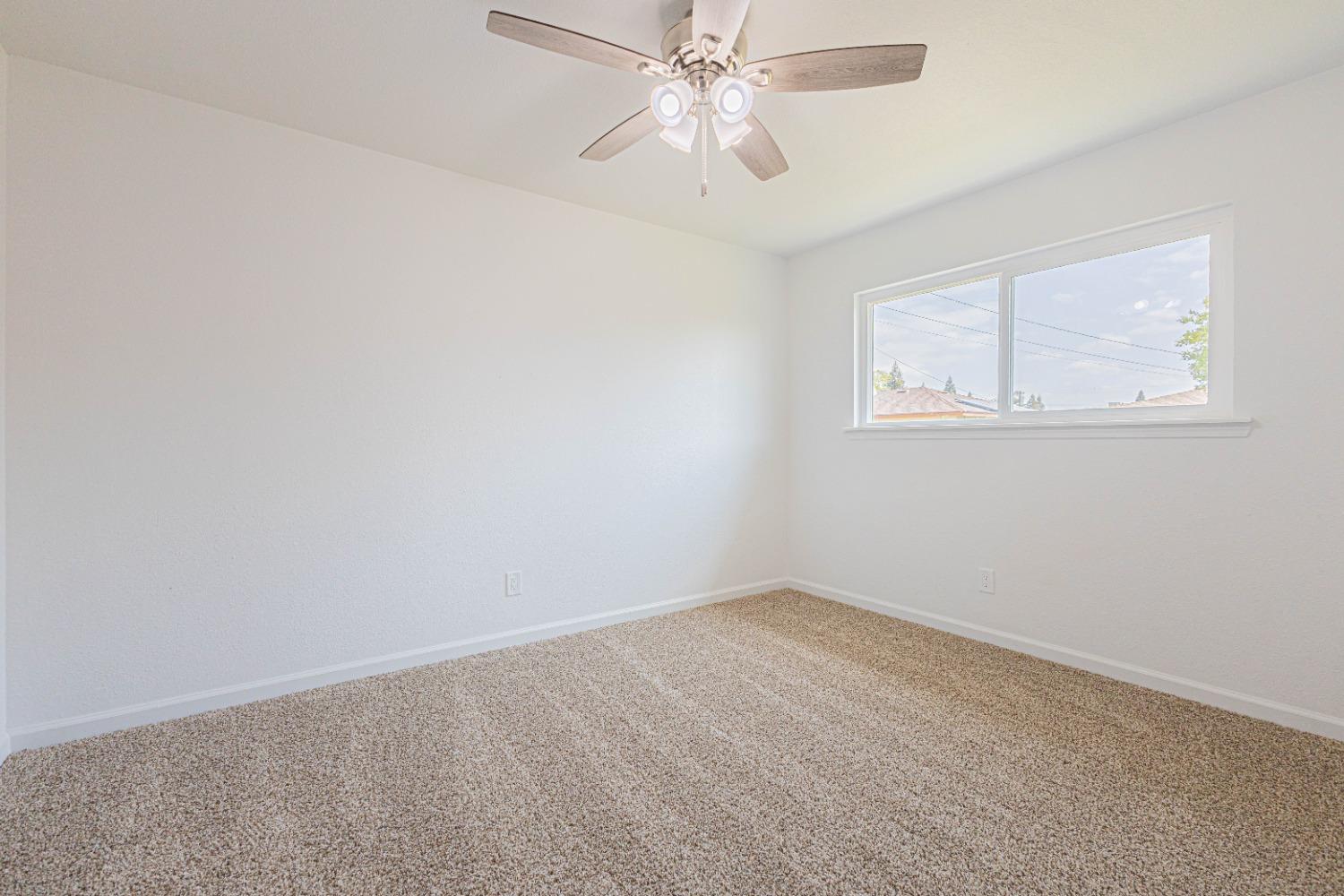 852 West San Gabriel Avenue Clovis, CA 93612 - Photo 11 of 16 an empty room with a window and a fan