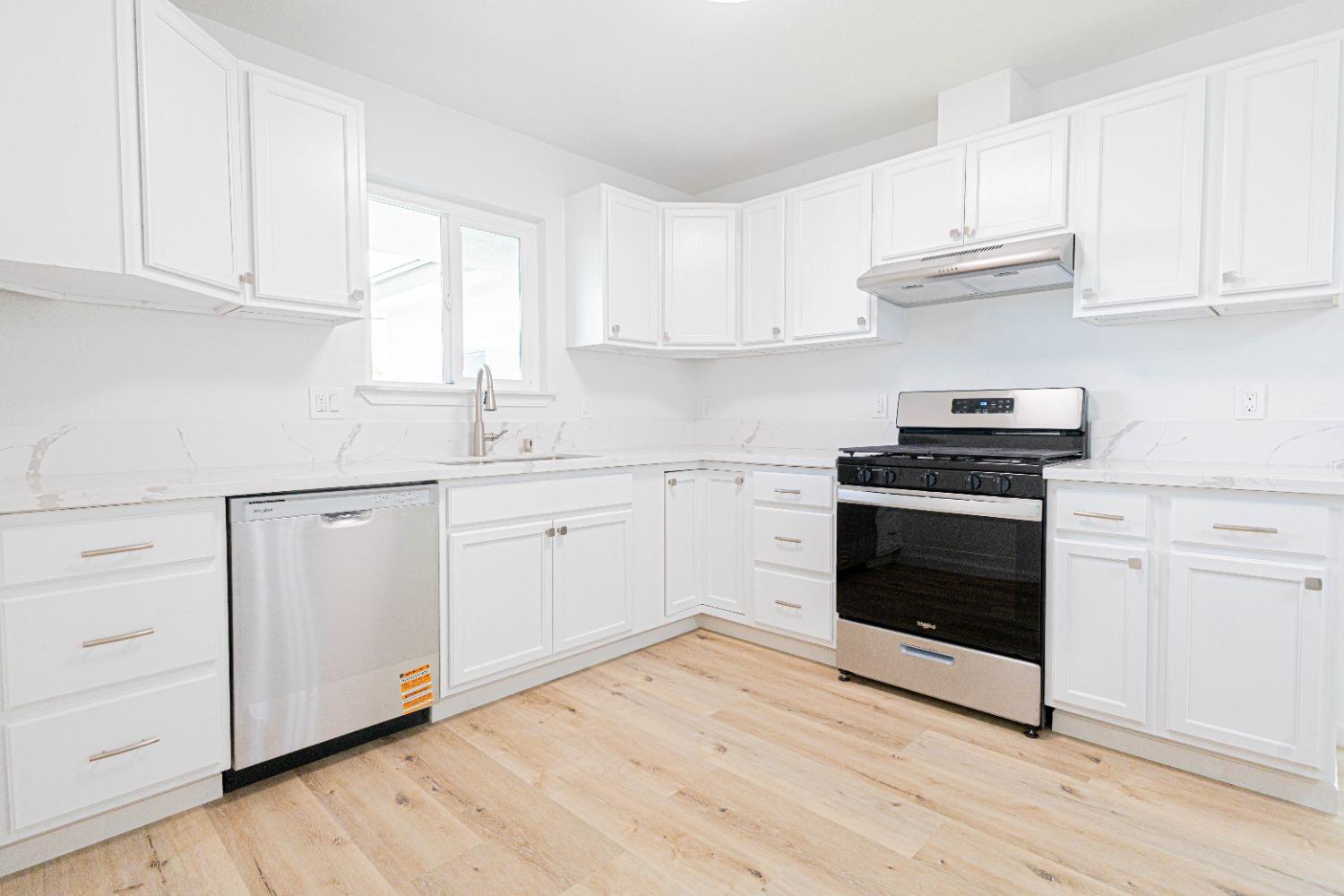 852 West San Gabriel Avenue Clovis, CA 93612 - Photo 5 of 16 a kitchen with white cabinets stainless steel appliances and sink