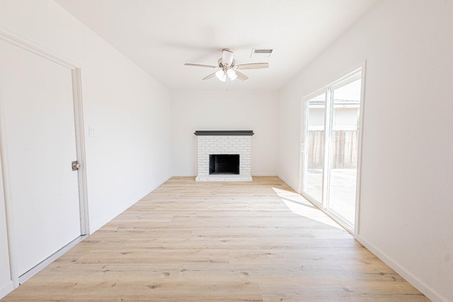 852 West San Gabriel Avenue Clovis, CA 93612 - Photo 6 of 16 an empty room with chandelier fan and windows