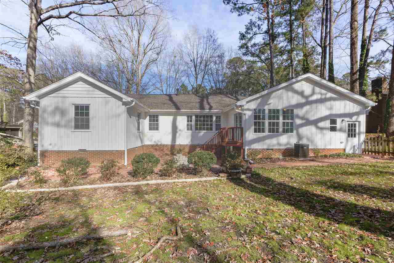 5205 Fieldstone Drive Raleigh, NC 27609 - Photo 13 of 13 Brick courtyard, including firepit, between the two "wings" of the house. Also, there is a brick/concrete patio on the lower level on the left of the house. Exterior Back