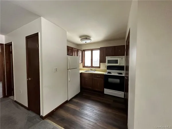 a kitchen with stainless steel appliances kitchen island granite countertop a refrigerator and a stove