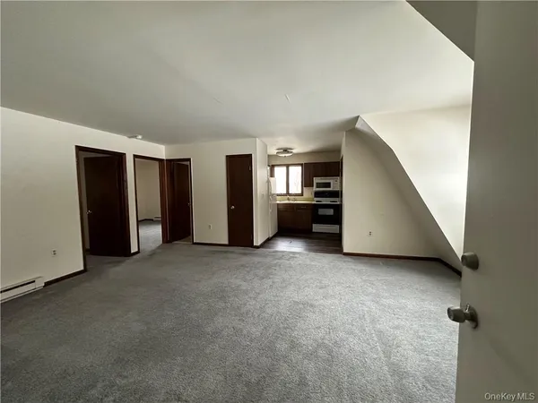 an empty room with furniture and a window