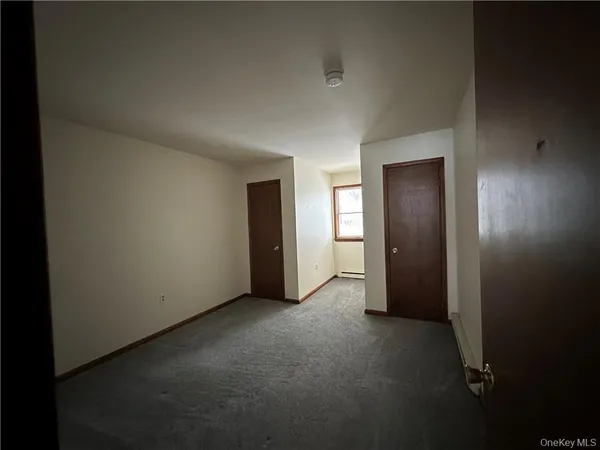 an empty room with closet area
