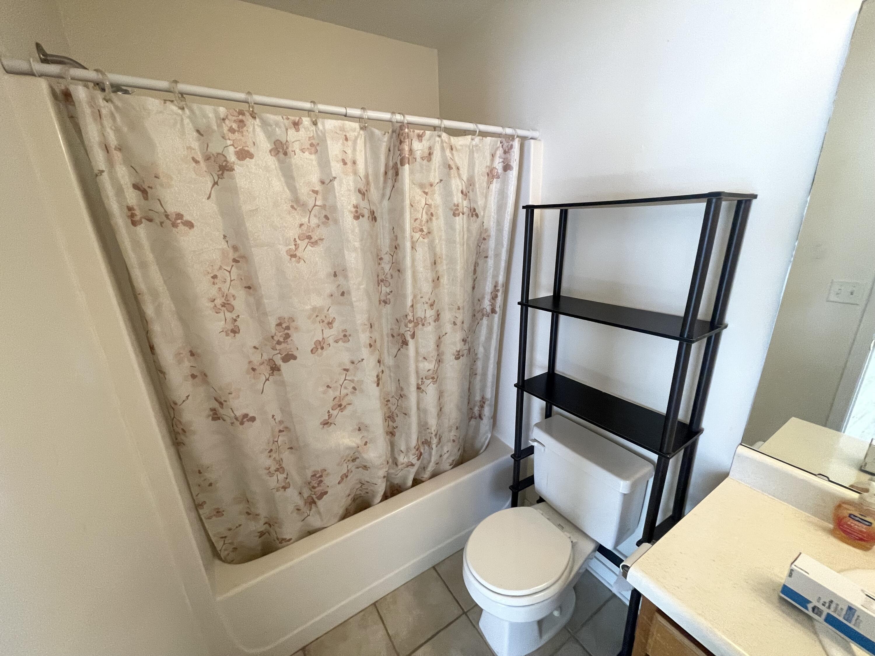 17 Shell Avenue Southeast, Unit B6 Fort Walton Beach, FL 32548 - Photo 6 of 11 a white toilet sitting next to a shower curtain