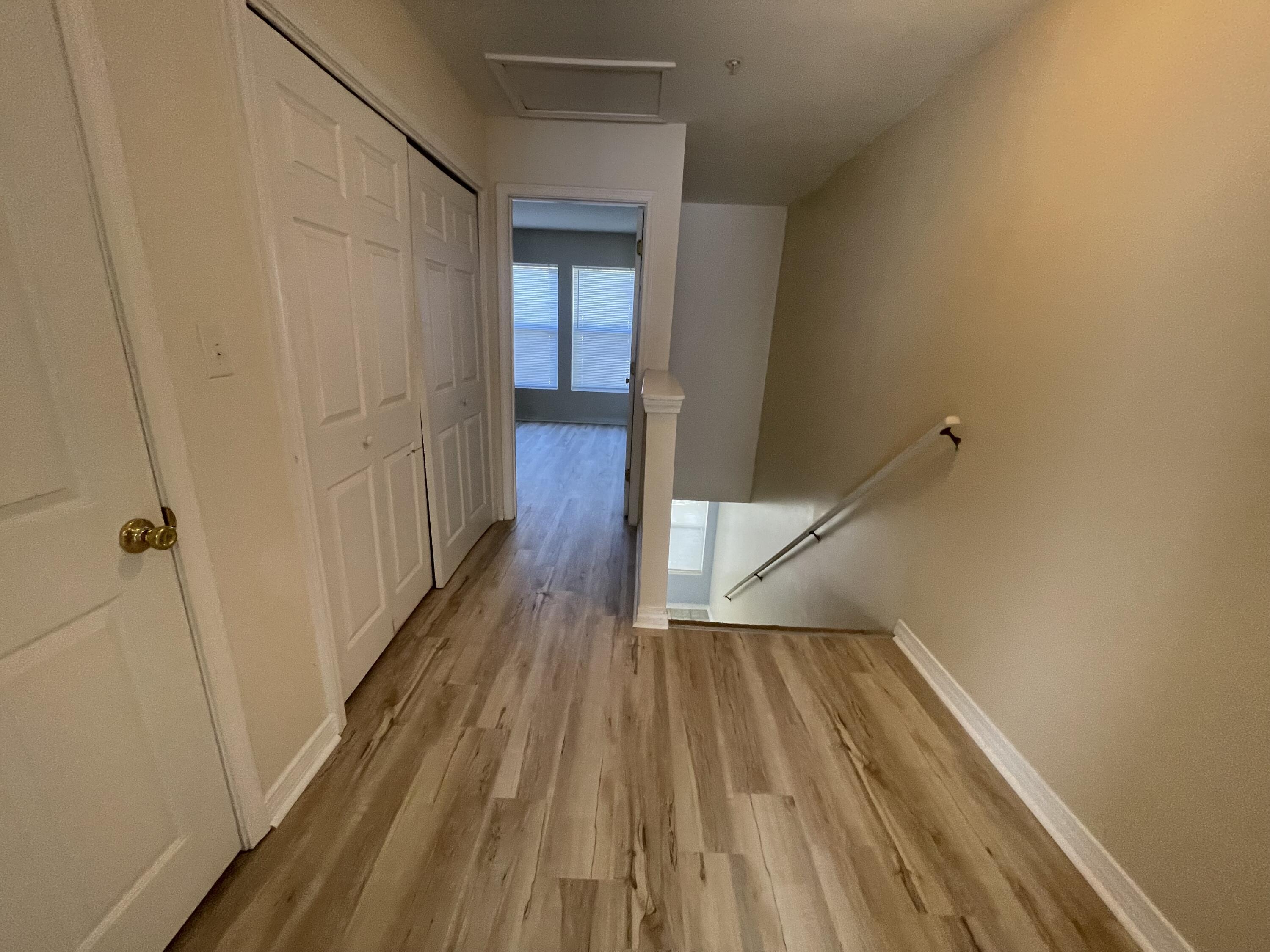 17 Shell Avenue Southeast, Unit B6 Fort Walton Beach, FL 32548 - Photo 8 of 11 a view of a hallway with wooden floor and staircase