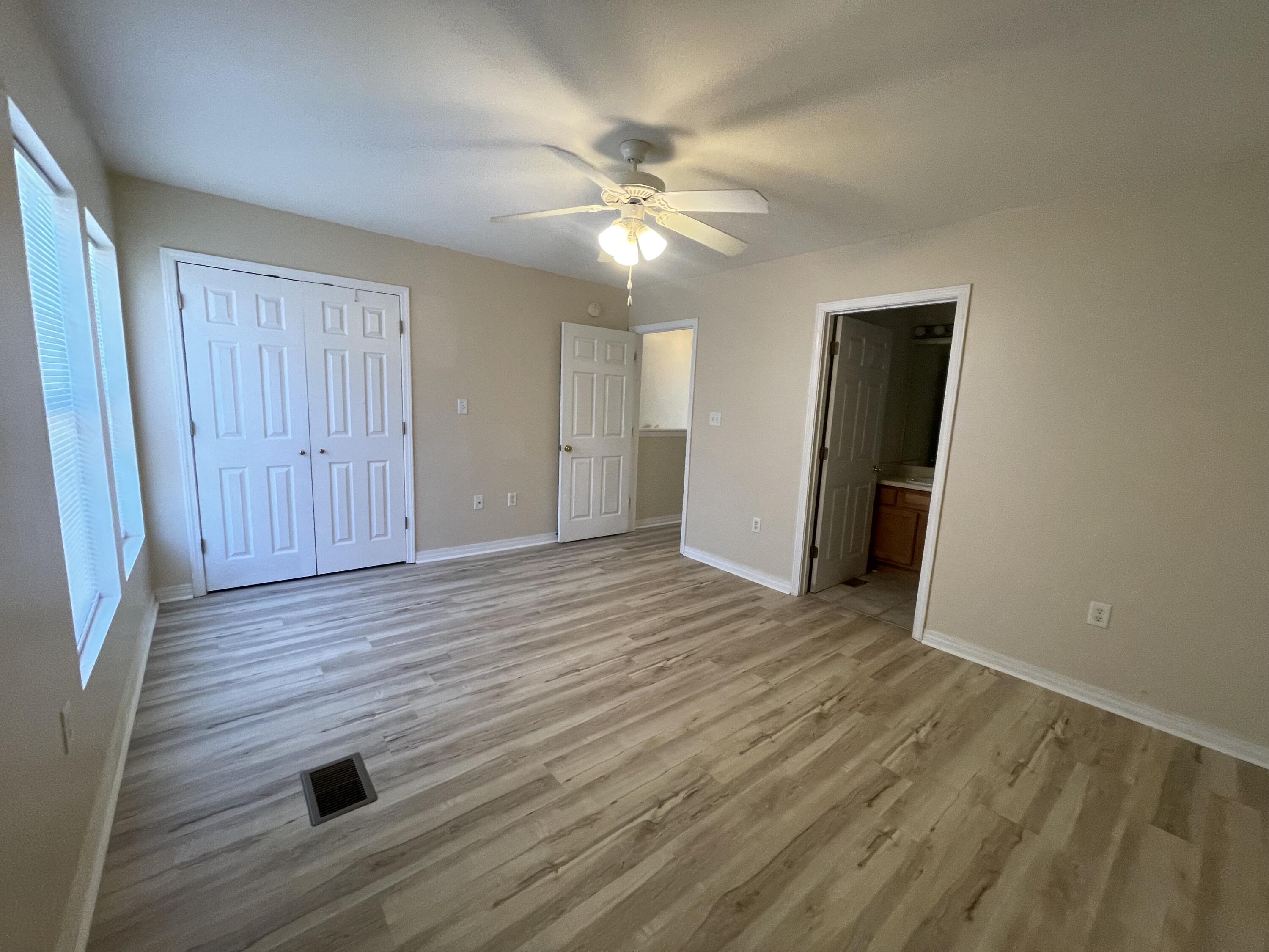 17 Shell Avenue Southeast, Unit B6 Fort Walton Beach, FL 32548 - Photo 9 of 11 wooden floor in an empty room with a window