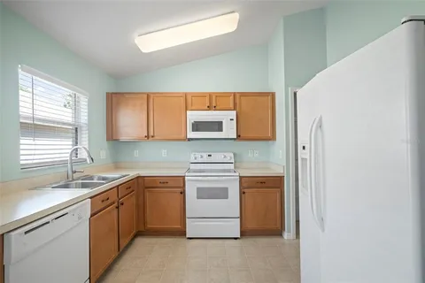 a kitchen with stainless steel appliances a stove sink and microwave