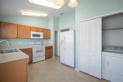 a kitchen with stainless steel appliances a refrigerator sink and stove