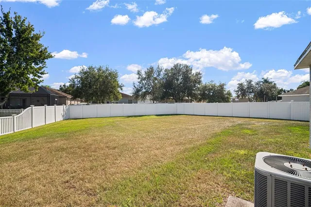 an aerial view of a house with a yard and lake