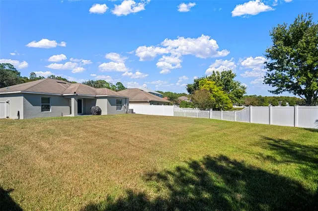 a front view of house with yard and trees