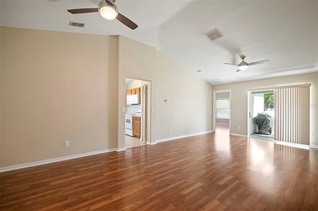 a view of an empty room with wooden floor