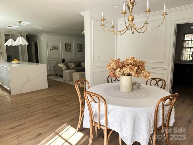 a dining room with furniture and wooden floor