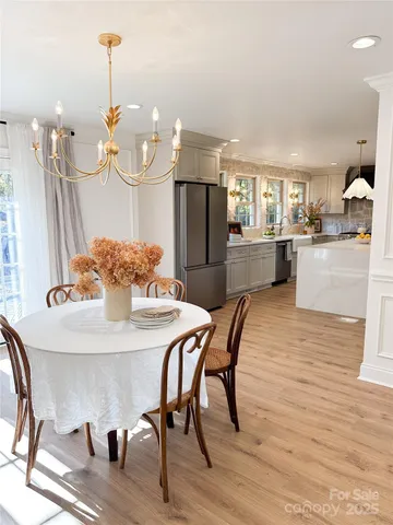 a dining room filled table and chairs