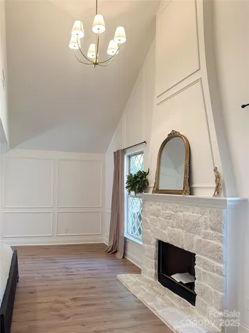 a living room with fireplace and wooden floor