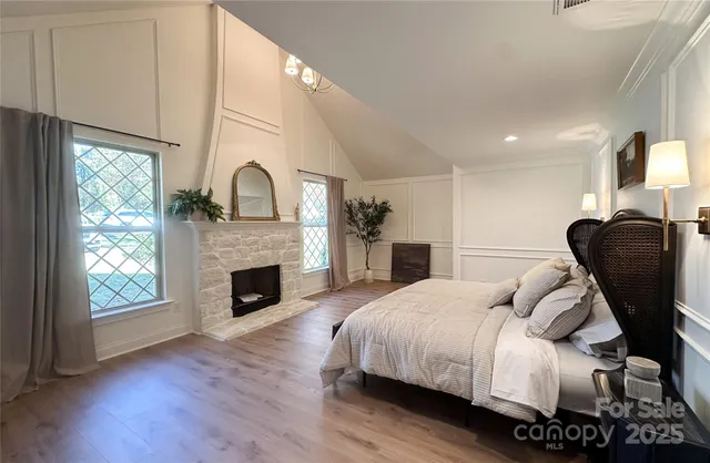 a bedroom with a bed and a fireplace