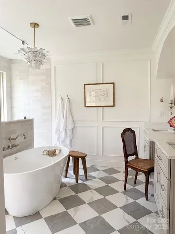 a living room with a couch and a chandelier