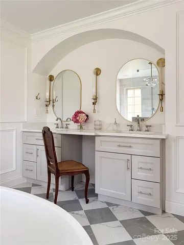 a spacious bathroom with a granite countertop sink and a mirror