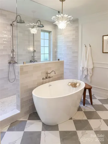 a spacious bathroom with a bathtub and shower