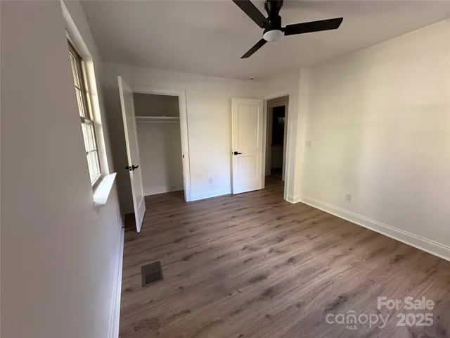 a view of a room with wooden floor and stairs