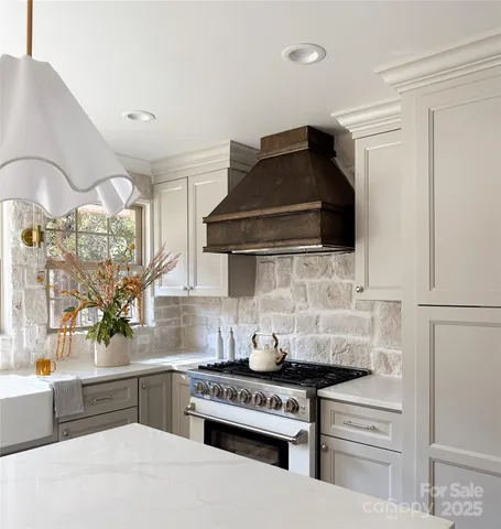 a kitchen with granite countertop a stove and a sink
