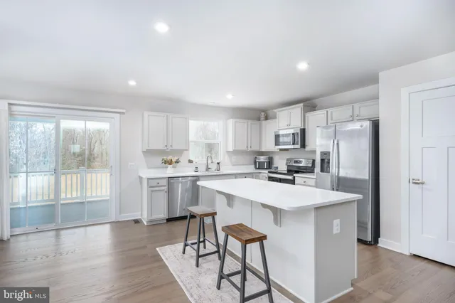 a kitchen with white cabinets and white appliances
