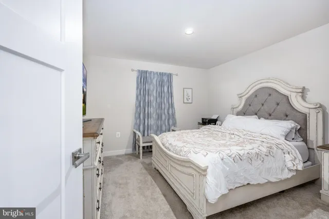 a bedroom with a bed and a mirror