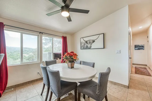 a dining room with furniture and window