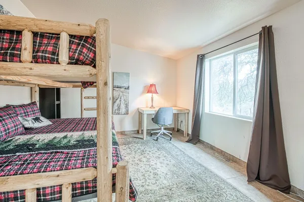 a bedroom with a bed and a chandelier