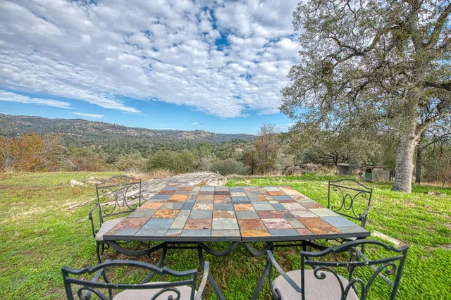 a view of a patio with lawn chairs under an umbrella