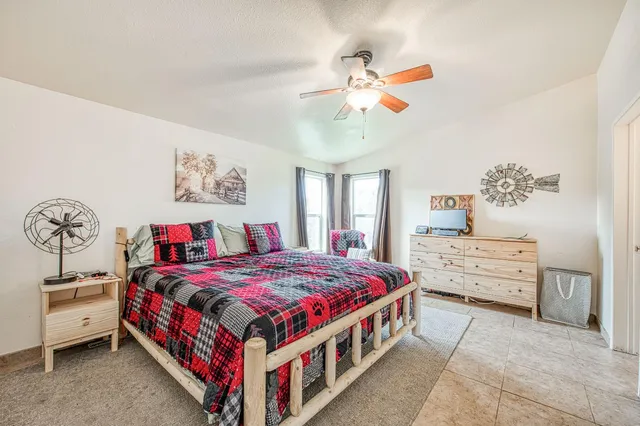 a bedroom with a bed a couch and a window