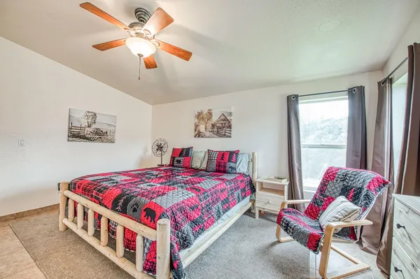 a bedroom with a bed and a chandelier