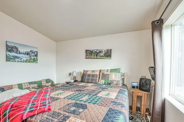 a bedroom with a bed and a window